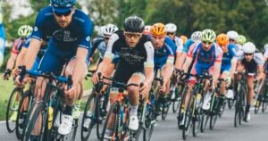 Homepage 13 Group of cyclists riding together in a pack on a road