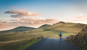Cyclists racing through scenic countryside roads during a professional stage race