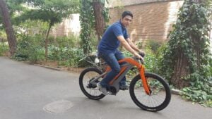 Homepage 21 Cyclist riding an electric commuter bike in traffic, illustrating V2X bike safety technology